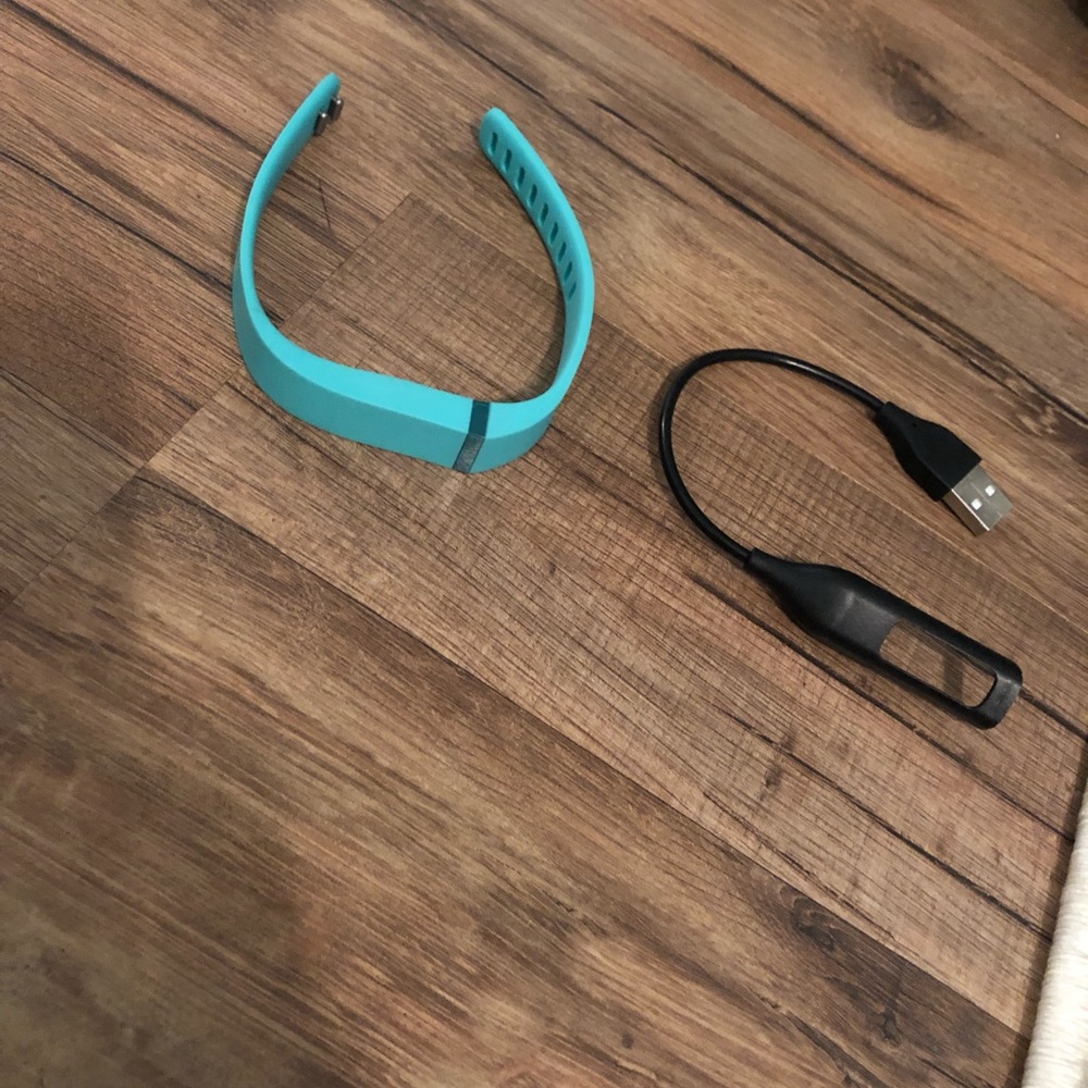 Teal Fitbit band and charger